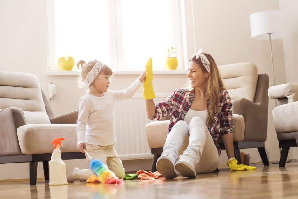 A mom and a daughter cleaning a living room