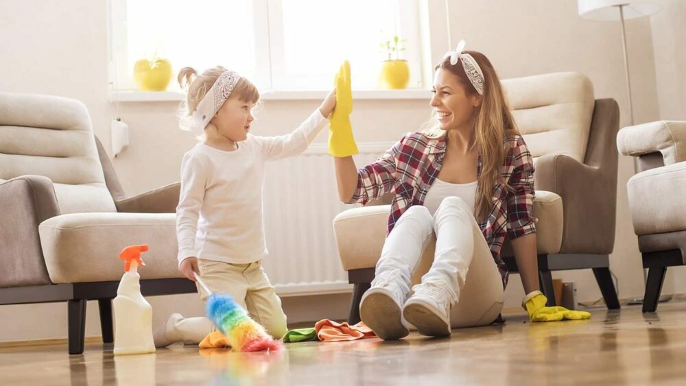 A mom and a daughter cleaning a living room
